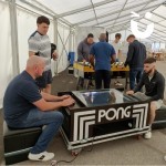 Atari Pong Table Hire in a marquee with 2 men playing during a corporate event