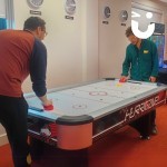 Air Hockey Table Hire at an indoor office event with 2 colleagues playing