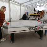 Air Hockey Table Hire at a corporate daytime event inside a marquee with a mother and daughter playing