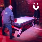 Air Hockey Table Hire at an evening indoor corporate event with a father and son playing
