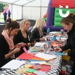 Women at our Crafts Workshop Hire creating postcards during a Fun Day Event