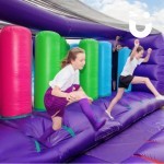 Assault Course Bish Bash Inflatable Hire at a school event with 2 girls excitinedly running through