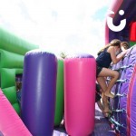 children playing on the inflatable assault course hire main