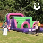 guest playing on the inflatable assault course main 