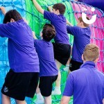Assault Course Cargo Net Hire 6 with 4 school children climbing up the net and a Fun Expert looking on