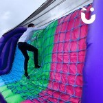 Assault Course Cargo Net Hire 7 with a man in office wear climbs up cargo net at a corporate event
