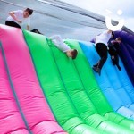 Assault Course Cargo Net Hire 9 with 5 school boys climbing over the evenflatable and jumping/sliding over back