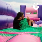 Assault Course Scramble Net Inflatable hire with a man lying on inflatable