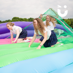 Girls racing through our Assault Course Scramble Net Inflatable Hire