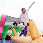 A young girl running across the Assault Course Balance Run Hire and trying to keep her balance at the same time
