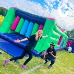 Assault Course Multiple Sections with 2 staff Fun Experts posing for the camera at a fun day