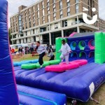 Assault Course Multiple Sections hire at a university event with 2 students running on the tyres