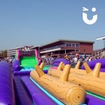 Assault Course Multiple Sections hire set up in a stadium at a corporate family fun day