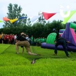 Assault Course Scramble Net 1 Hire two men runnin under scramble net at a corporate team build whilst other competiters watch on