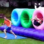 Assault Course Inflatable Tunnels 2 Hire at a corporate team build event with 2 men running through tunnels