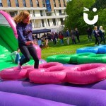 Assault Course Inflatable Tyres hire at a university event with a student running over tyres