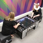two Fun Experts playin on the Atari Pong Table Hire during their break at the office 