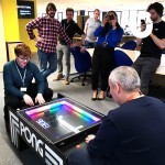 Our Atari Pong Table Hire bringing in the crowds wanting to take pictures of it in use in their offices