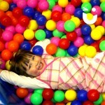 A young Girl laughing whilst playing in the Ball-Pool Hire