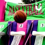 The Basket ball is in midair and about o drop into one of the nets
