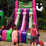 Basketball Inflatable Hire 4 set up outside on a hard ground at a family fun day with a mix of ages having a go
