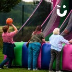 Basketball Inflatable Hire 6 set up outside at a corporate event with 3 people competing