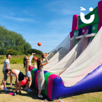 Four people throwing balls at the Basketball Inflatable