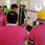 Batak Hire 2 at an indoor corporate team building event with a team of men in matching pink tshirts try to earn the quickest score