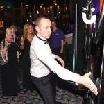 Batak Hire 5 at a black tie corporate evening ceremony with a man concentrating hard on the Batak and people watchin on in awe
