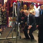 Batak Hire 7 at an office party with a business man havong a go on the batak with a crwd of happy on lookers and stalls in the background