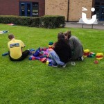 Big Rubber Lego 2 at a university event with 4 students sat consentrating hard on building lego
