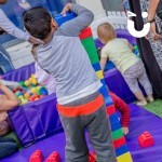 Big Rubber Lego 3 at a fmily fun day with a young boy building a lego tower