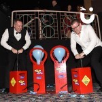 Two gentlemen at a corporate awards evening enjoying the Boom Balloon Blasters Hire