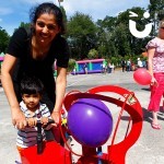 A mother and son smile for the camera whilst having fun on our Boom Balloon Blasters Hire