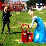 Elsa from Frozen attempting to use the Boom Balloon Blasters Hire and pop her balloon