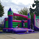 Young adults playing on the adult bouncy castle hire