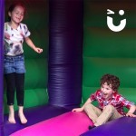 A boy and girl laughing and enjoying the Bouncy Castle Hire Childrens