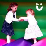 Two young girls holding hands on our Bouncy Castle Hire Childrens