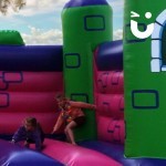 Childrens Turret Bouncy Castle Hire with 2 young girls having fun