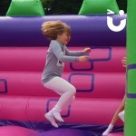 Childrens Turret Bouncy Castle Hire with a young girl bouncing