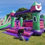 Event Bouncy Castle set up outside at a University event with student having a bounce