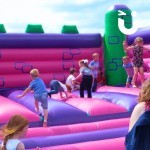 Large Event Castle 3 at a family fun day with lots of children bouncing
