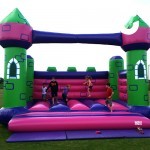 children playing having fun on the bouncy castle hire