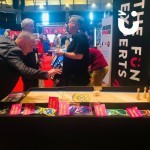 Bowl O Rama Table 2 at an exhibition with a man rolling the ball towards the skittles