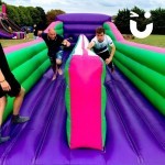 Bungee Run Hire at a family fun day with father and adult son competing for the win