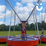 Bungee Trampolines Hire 5 at a corporate family day being used by 2 young boys