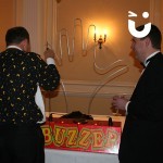 Two men trying out our Hand Buzz wire Hire during a corporate awards evening