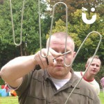 A man carefully concentrating on guiding the wand through the Hand Buzz wire Hire 