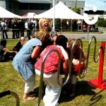 A group of ladies can't control the laughter as they take on the challenge of the Human Buzz Wire Hire. With one of their team mates donning the hoop helmet and supported by the rest of the team as a wand, the fun can't be controlled.