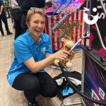 Exhibition guest crouched beside the Mega Buzz Wire at our Exhibition stand